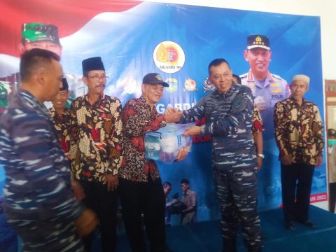 Pangkoarmada II, Laksamana Muda TNI Yayan Sofiyan, memberikan paket Sembako kepada salah seorang warga Bakti Sosial Altar 1989 TNI-Polri di wilayah Surabaya, Sabtu (26/8/2023)